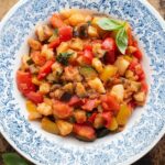 An overhead cropped image of Ciambotta Italian summer stew in a blue and white bowl.