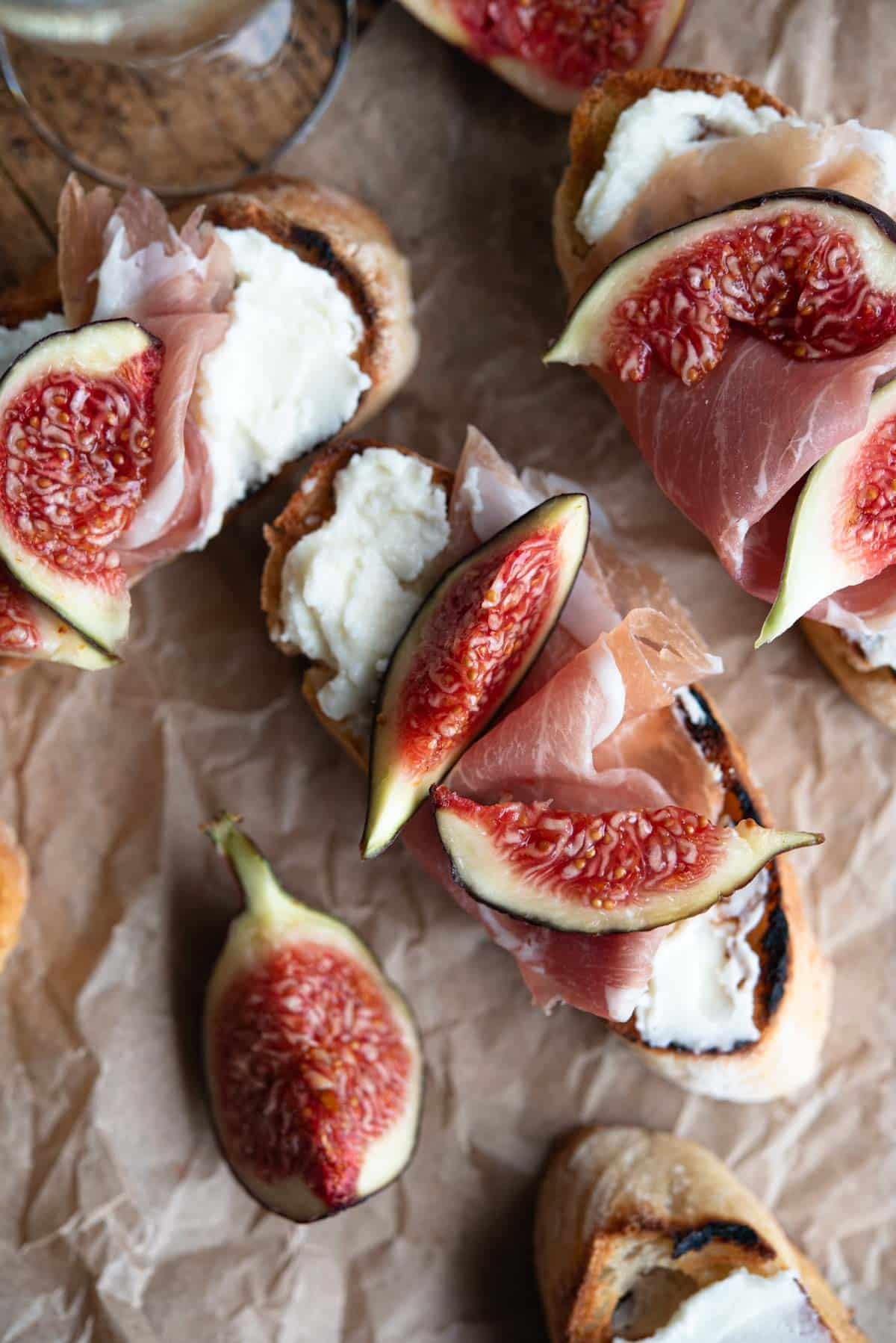 An overhead shot of crostini with figs, pecorino cream and prosciutto.