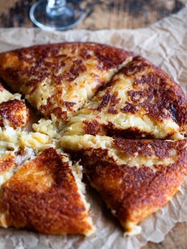Frico (fried cheese and potato) on a wooden surface.