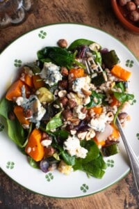 An overhead shot of a warm farro salad with butternut squash, spinach and gorgonzola.
