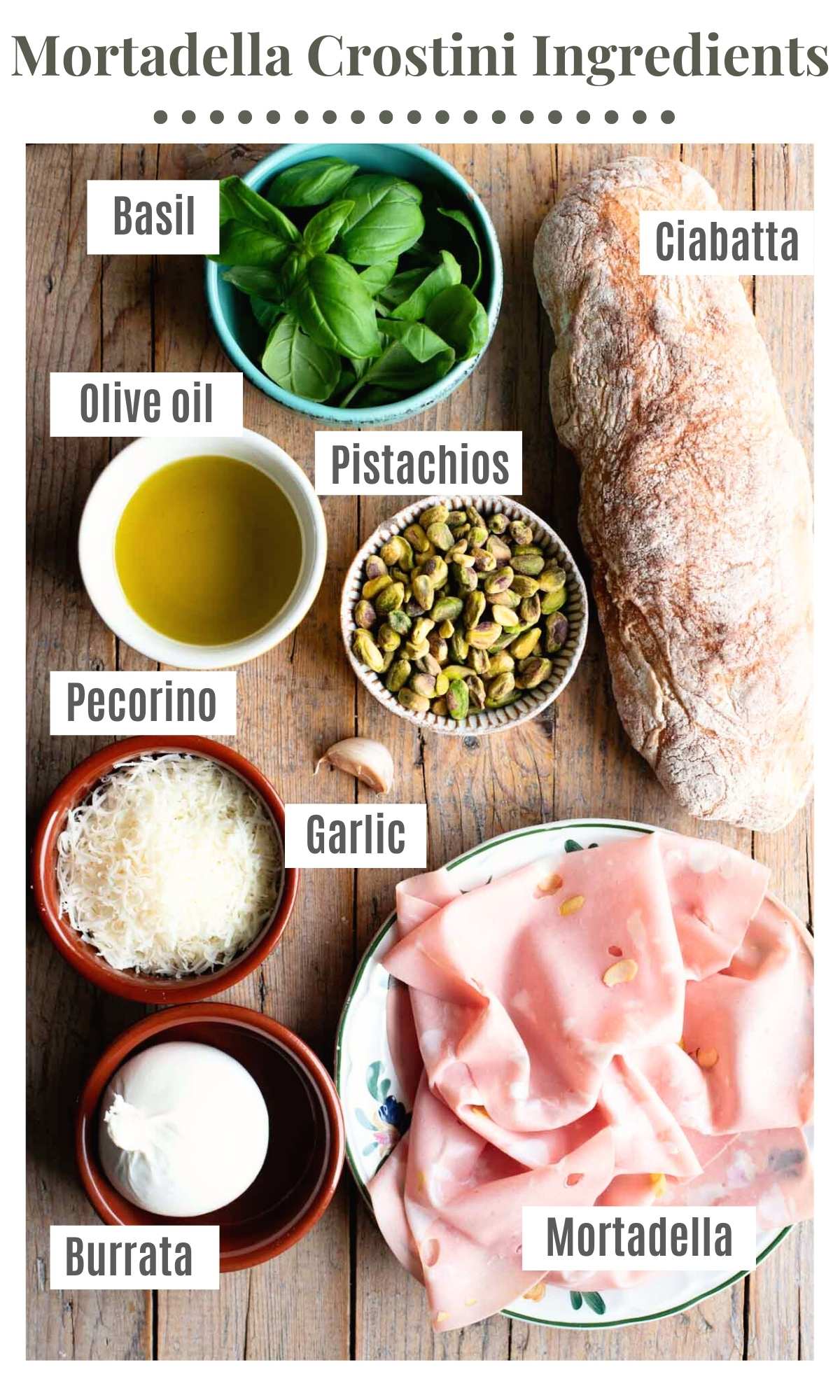 An overhead shot of all the ingredients needed to make mortadella crostini with pistachio pesto and burrata.