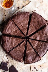 An overhead shot of an Italian flourless chocolate cake cut into slices.