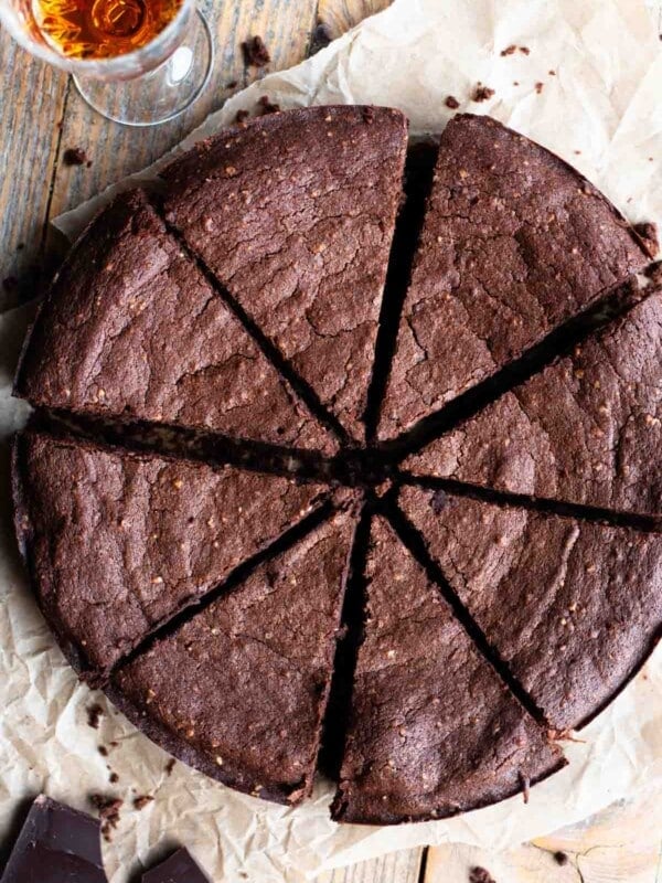 An overhead shot of an Italian flourless chocolate cake cut into slices.