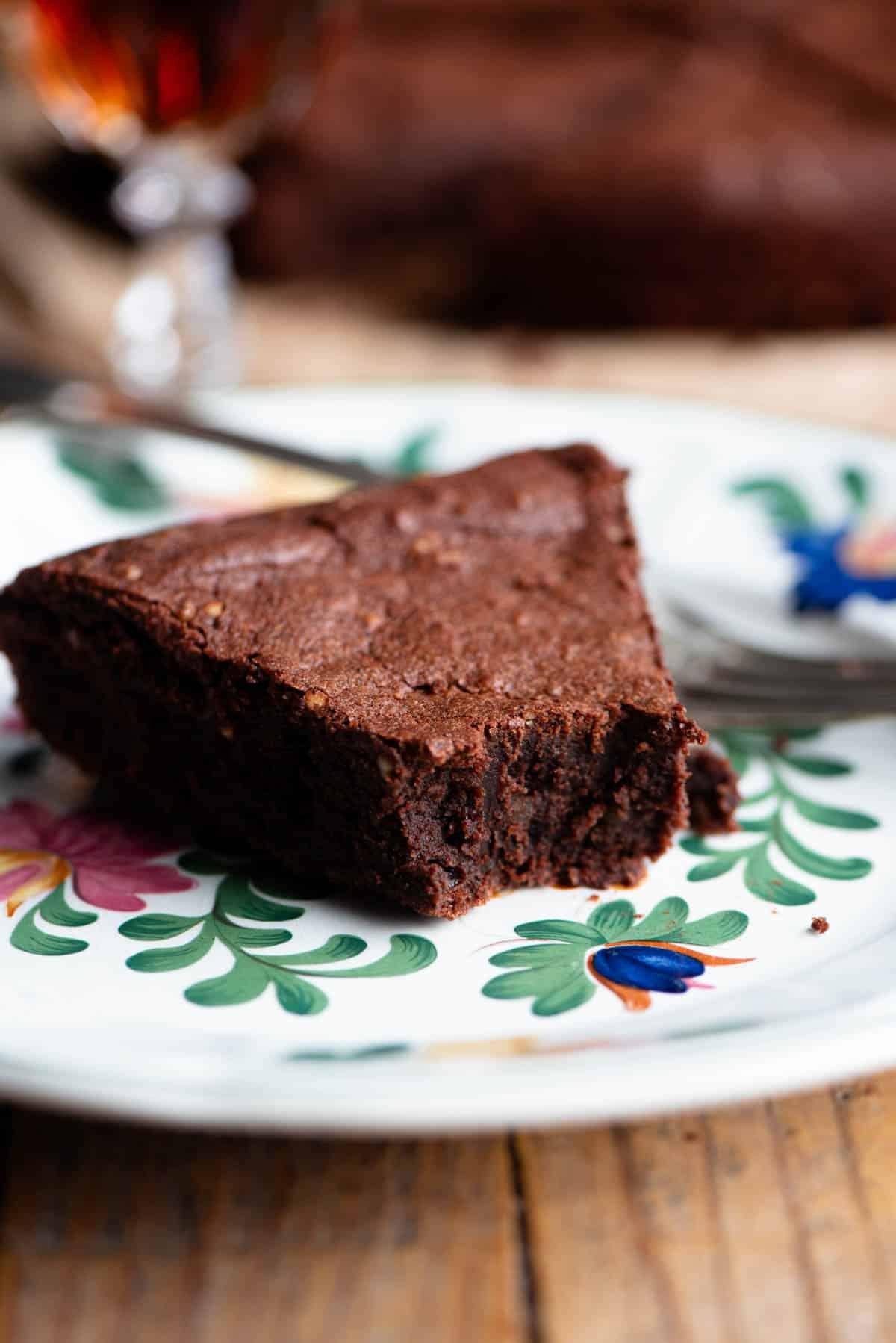 A close up of a slice of Italian chocolate cake on a plate with a fork.