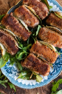 An overhead shot of Sicilian involtini on skewers with breadcrumbs.