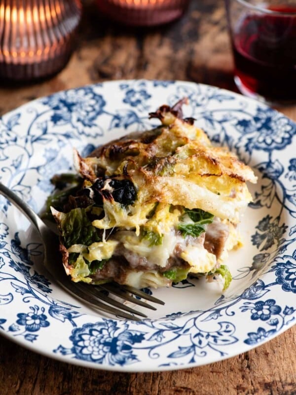 A slice of a rustic Italian casserole on a blue plate.