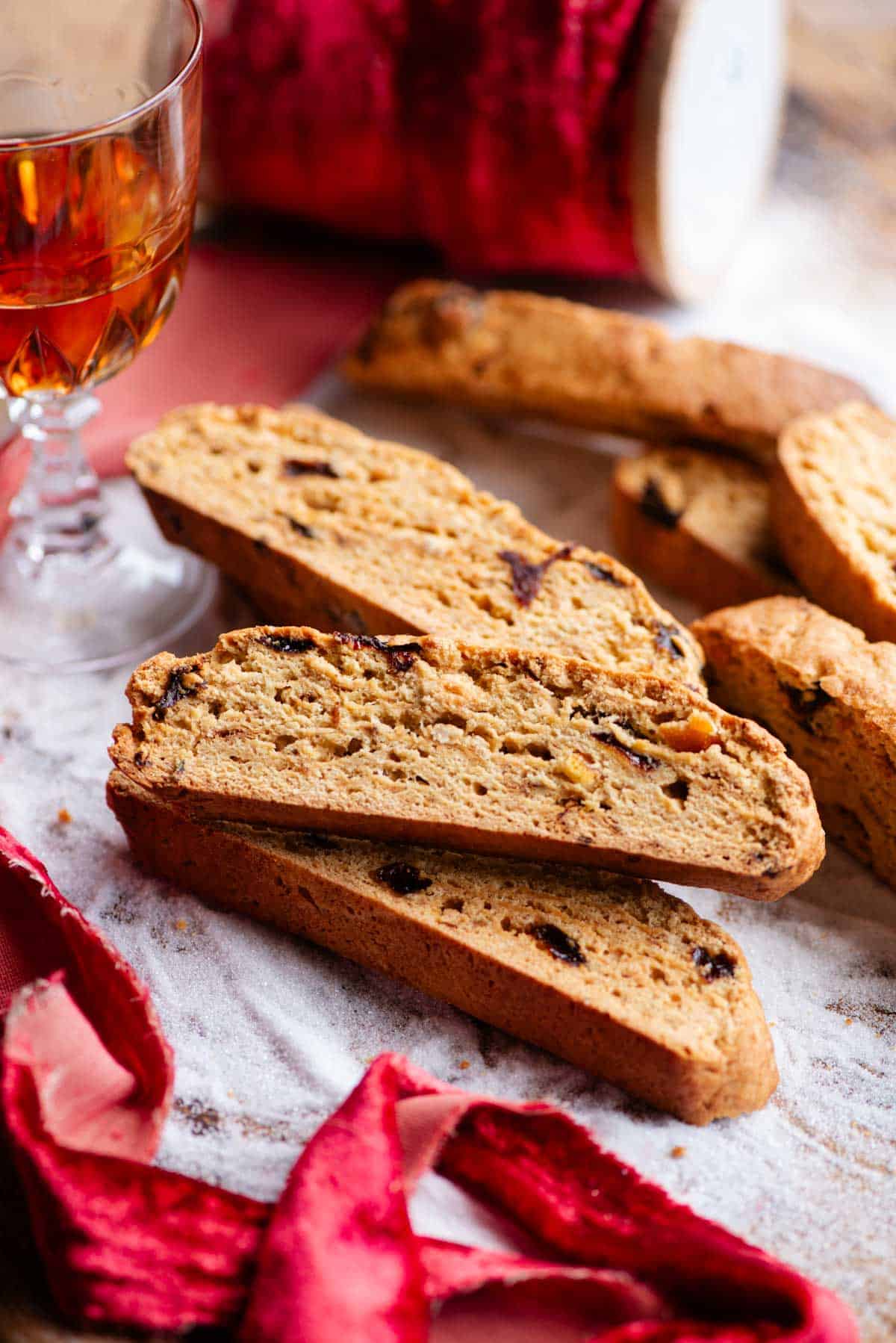 A close up side shot of Panettone Biscotti on a wooden board covered with sugar.