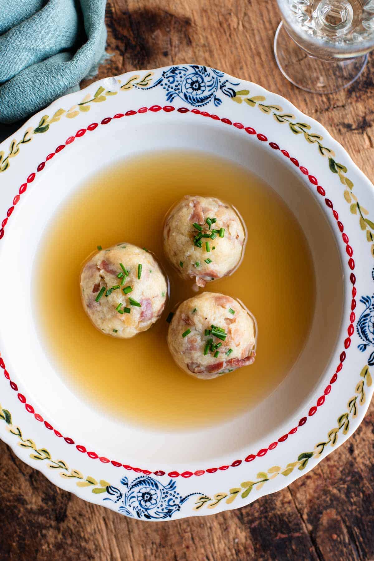 An overhead shot of Canederli, Italian bread dumplings in broth.