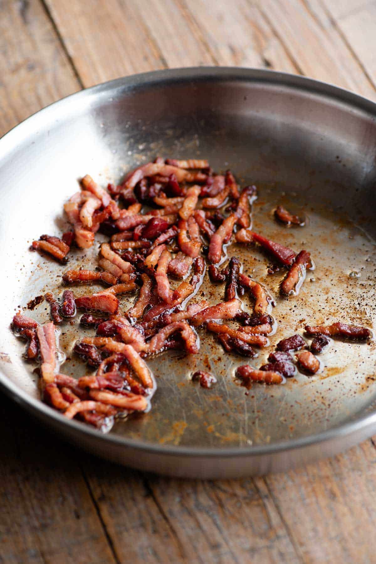 A frying pan with crispy pancetta.