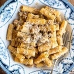 A creamy meat sauce with rigatoni in a country style blue and white bowl.