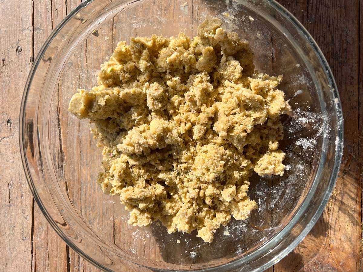 pastry dough in a rough crumb texture in a glass bowl.