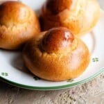 A close up of a Sicilian brioche on a plate that white with green flowers.