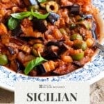 A pinterest graphic of Sicilian caponata showing a close up side shot of it in a blue and white bowl. The text overlay reads: Sicilian Caponata - authentic recipe.