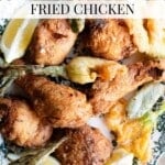 A Pinterest graphic showing Italian fried chicken thighs and drumsticks on a plate with zucchini blossoms and sage.