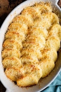 A close up of Gnocchi alla Romana in a baking dish topped with Parmigiano cheese.