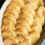 A close up of gnocchi alla Romana in a baking dish topped with Parmigiano Reggiano cheese.
