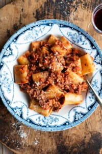A blue and white vintage style bowl with paccheri and hazelnut ragu.