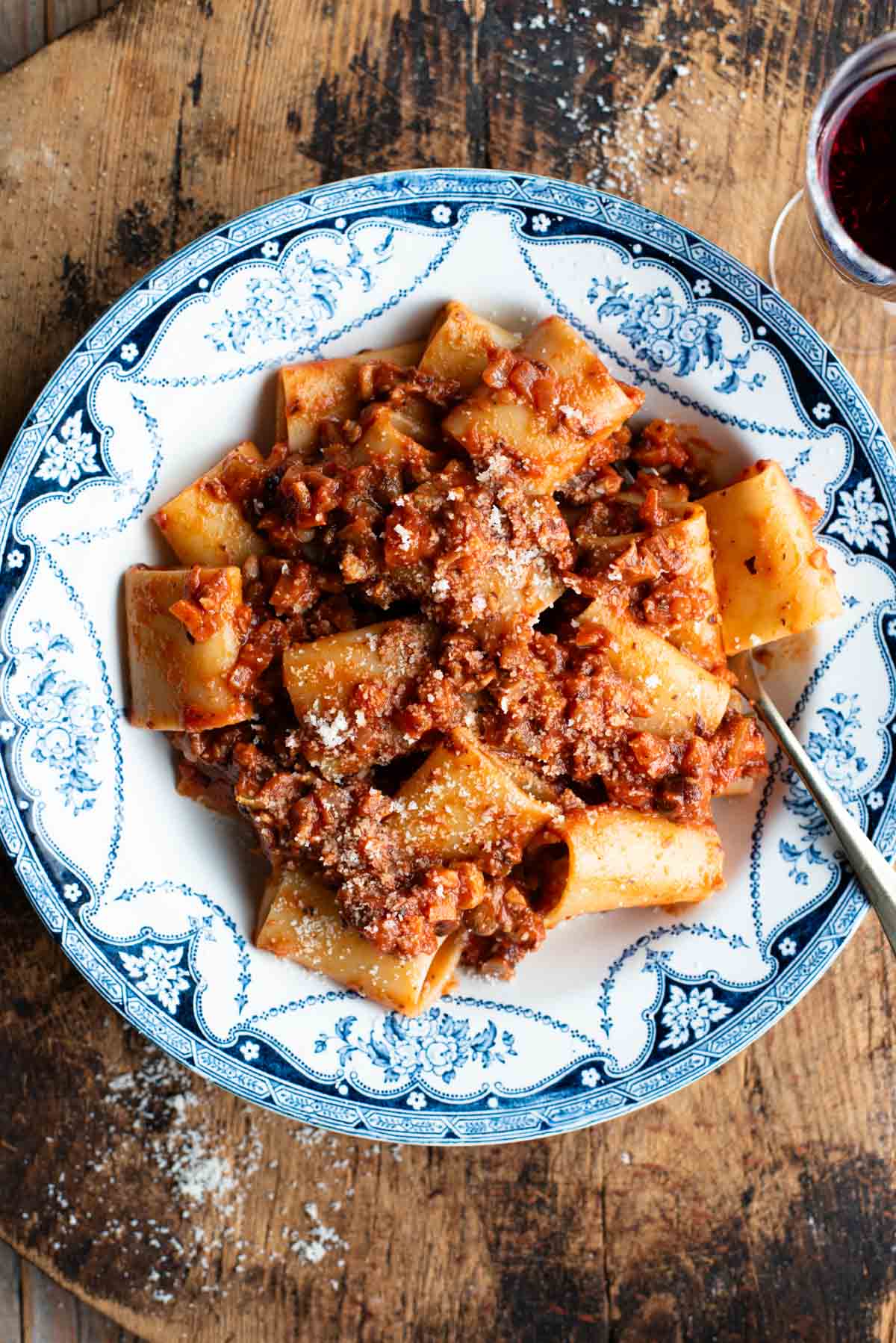 A blue and white vintage style bowl with paccheri and hazelnut ragu.
