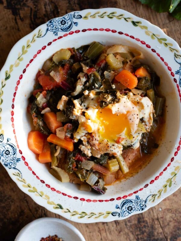 A Tuscan soup called Acquacotta in a vintage style bowl topped with a poached egg.