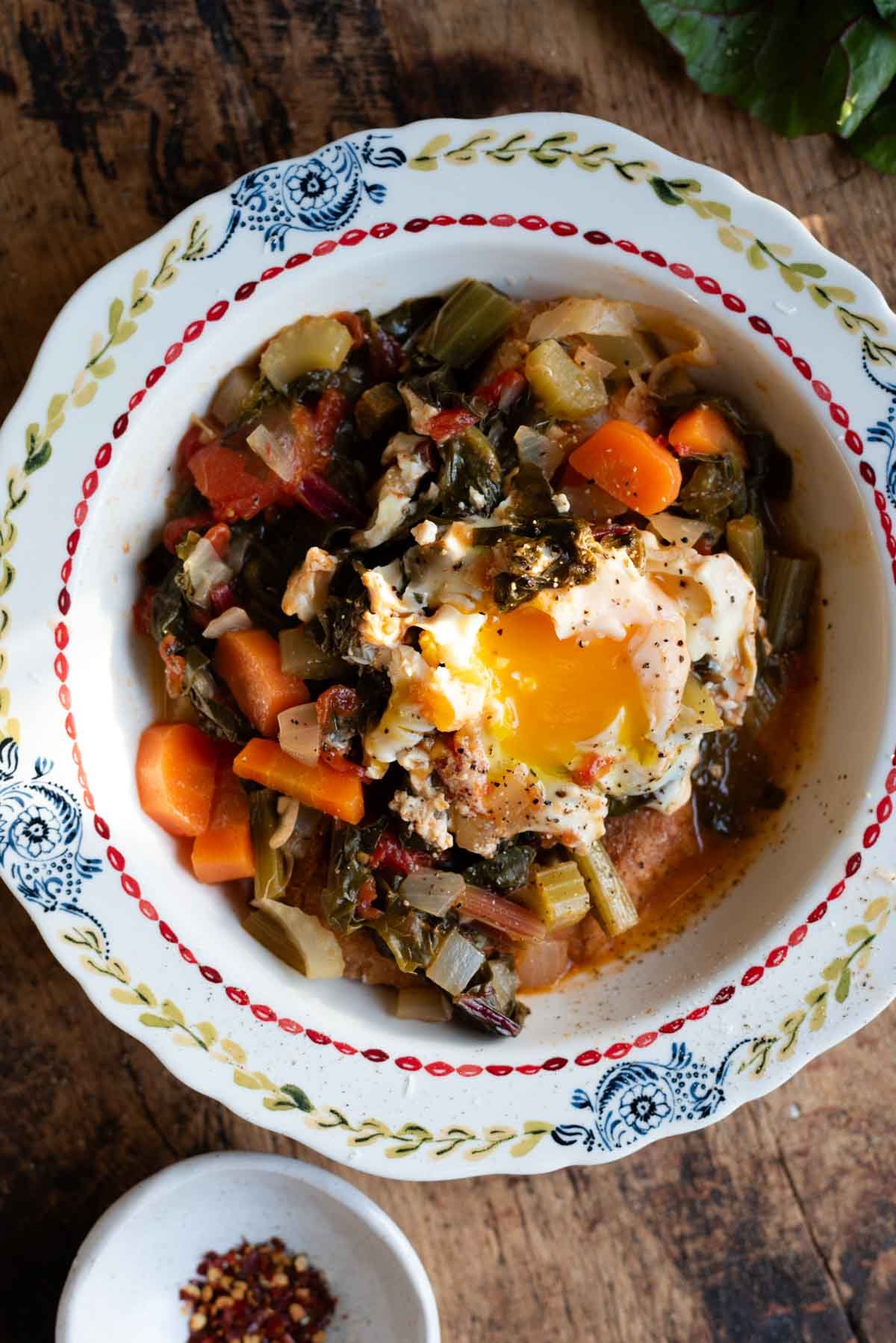 A Tuscan soup called Acquacotta in a vintage style bowl topped with a poached egg.