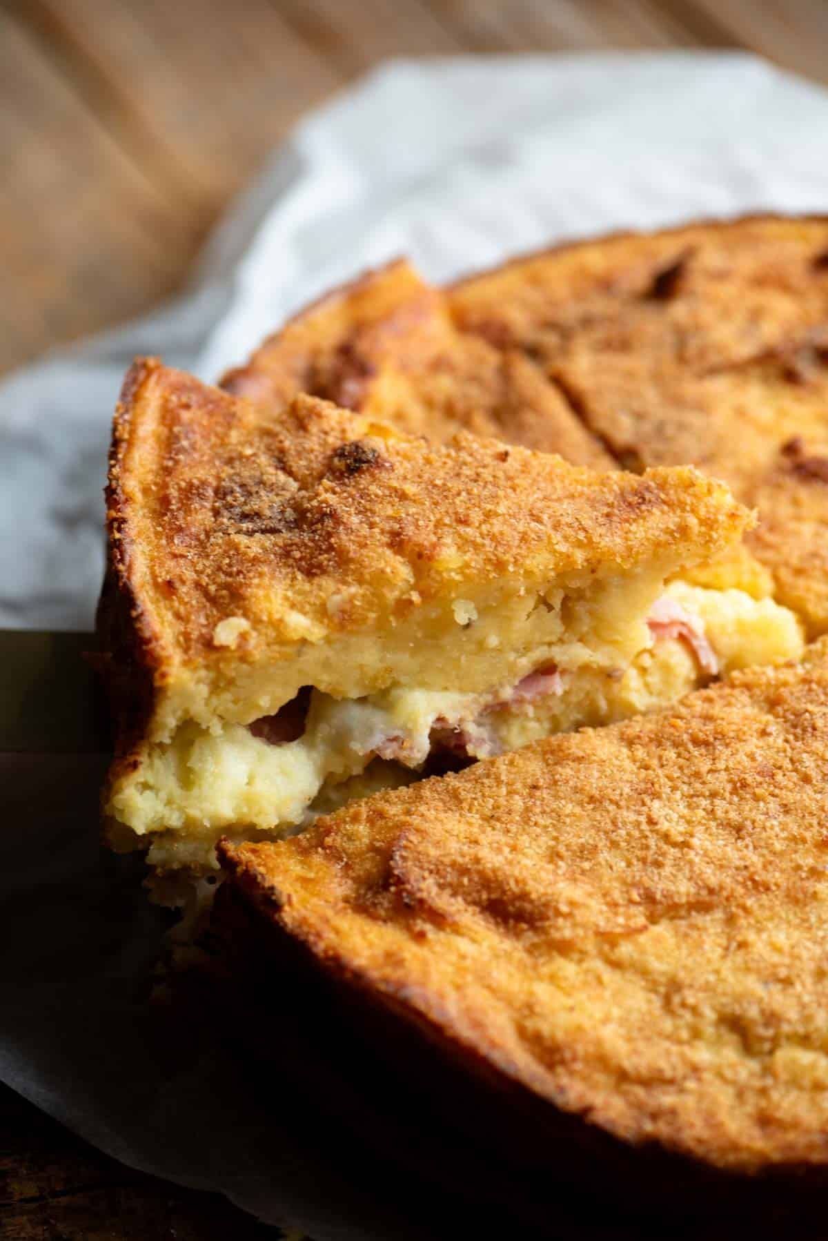 A close up of a slice of Neapolitan potato cake.