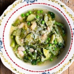 A close up of an Italian spring vegetable soup (minestrone primavera) in a vintage style bowl.