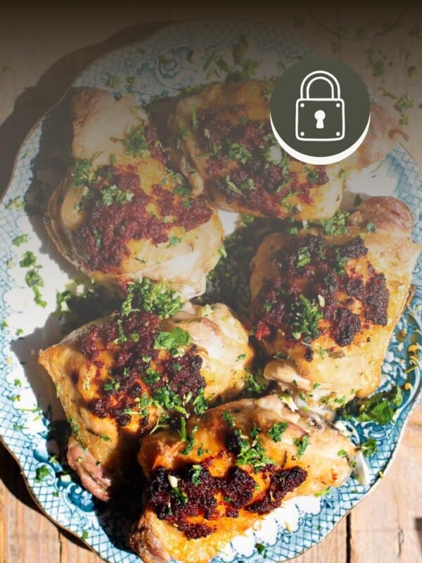 Nduja baked chicken on a serving platter with a padlock symbol at the top to signify a members only recipe.