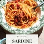 A pinterest graphic showing a bowl of tomato spaghetti with sardines. The text overlay reads Sardine Tomato Pasta - get the recipe.