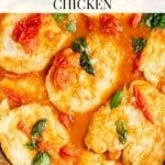 An overhead shot showing chicken in a pan with a tomato and basil sauce. The text overlay reads; Cherry tomato and basil chicken.