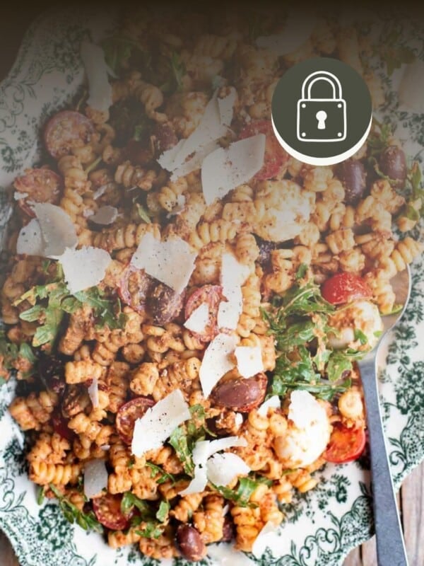 A sun-dried tomato pasta salad with a padlock sign at the top right hand corner to signify a member only recipe.