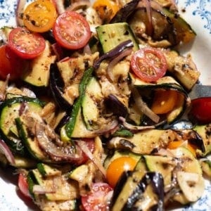 A close up of marinated summer vegetables in a bowl.