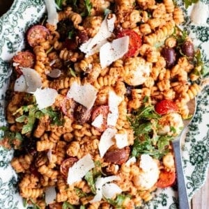 A close up of sun-dried tomato pasta fredda on a serving plate.