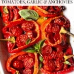 A pinterest graphic of roasted stuffed red bell peppers in a white baking dish topped with basil. The text overlay reads; Italian stuffed peppers - tomatoes, garlic and anchovies.
