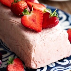 A close up of strawberry semifreddo topped with fresh cut strawberries.