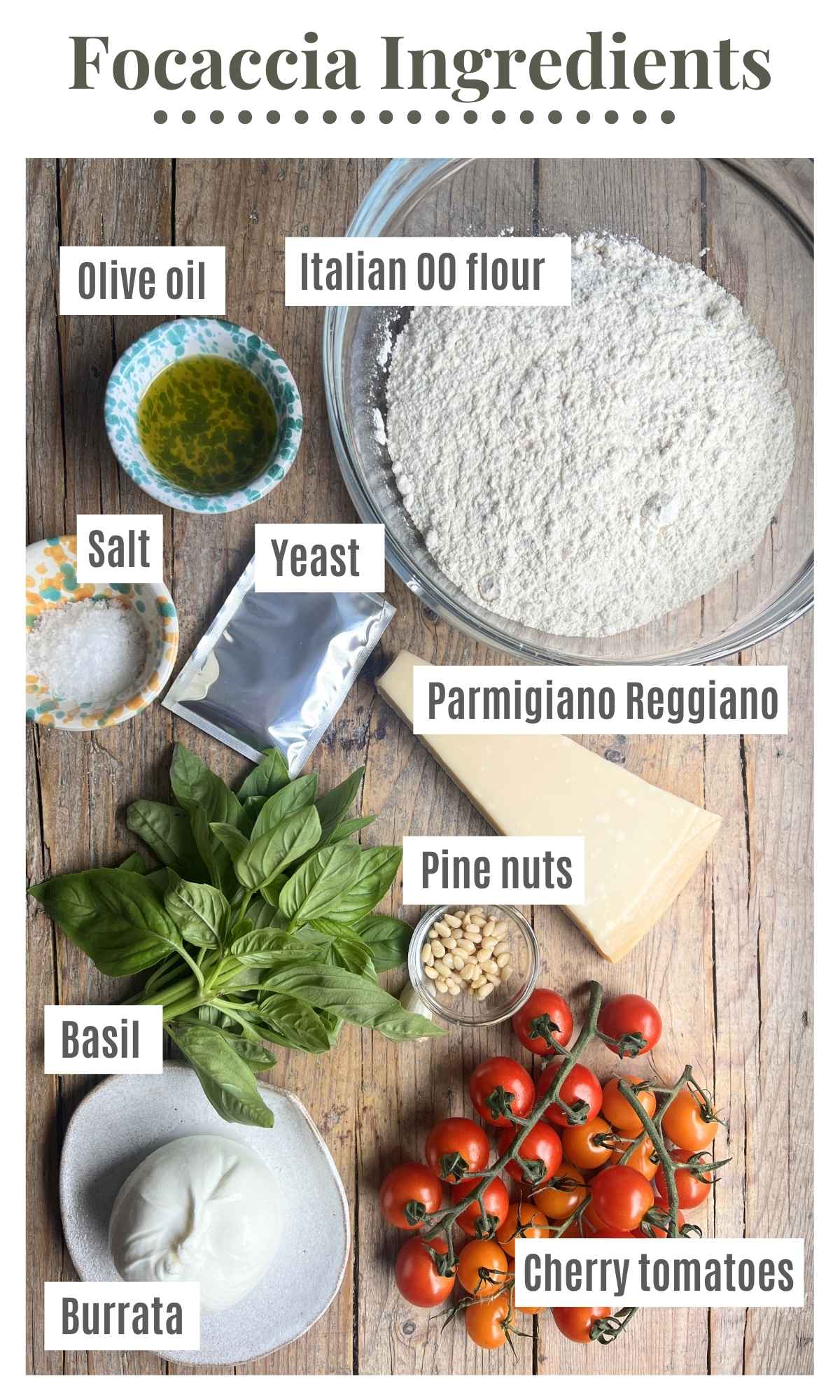 Ingredients laid out on a rustic wooden surface to make a focaccia with cherry tomatoes, basil pesto and burrata.