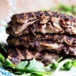 A close up of beef stuffed with cheese, radicchio and porchetta on a plate with arugula at the side.