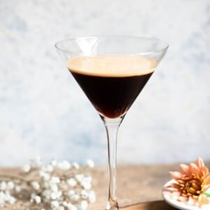 A close up of a cocktail glass filled with an iced coffee.