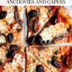A close up of an olive, caper and anchovy pizza with a text overlay that reads Pizza with olives, anchovies and capers.