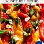 A close up of marinated red and yellow bell peppers with garlic and basil. The text overlay reads; Italian marinated roasted bell peppers.