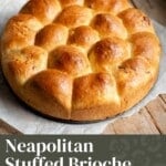 A pinterest graphic with a text overlay that reads; Neapolitan Stuffed Brioche with cheese and ham - get the recipe. The brioche bread is above on a rustic wooden surface.