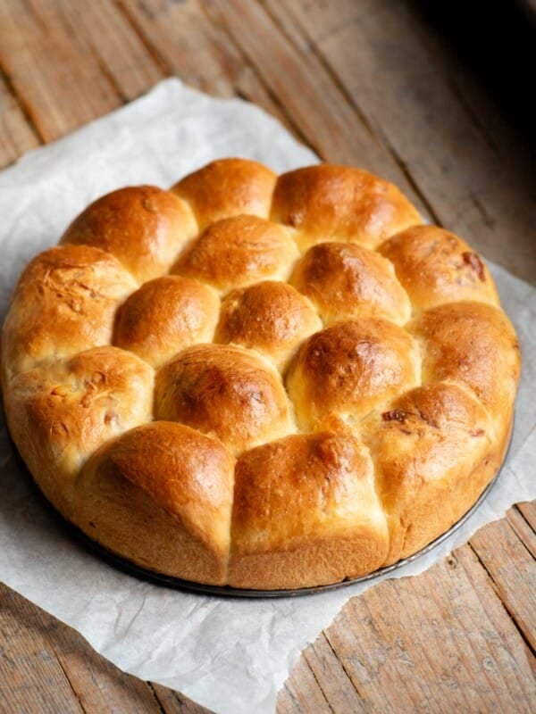A neapolitan brioche bread (danubio salato) sitting on a rustic wooden surface.