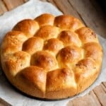 Danubio salato (neapolitan pull apart bread) on a rustic wooden surface.