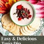 A pinterest graphic of a tuna dip on a platter with fresh vegetables. The text overlay reads; Easy and Delicious Tuna Dip - Perfect Party Appetizer.