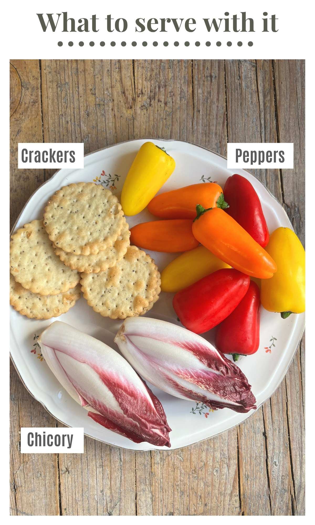 An overhead shot of mini peppers, crackers and chicory on a plate.